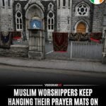 Les migrants musulmans continuent d'accrocher leurs tapis de prière aux grilles à l'extérieur de l'église…