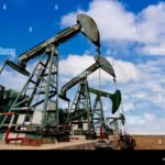 working-oil-pump-jacks-on-a-oil-field-EB659E